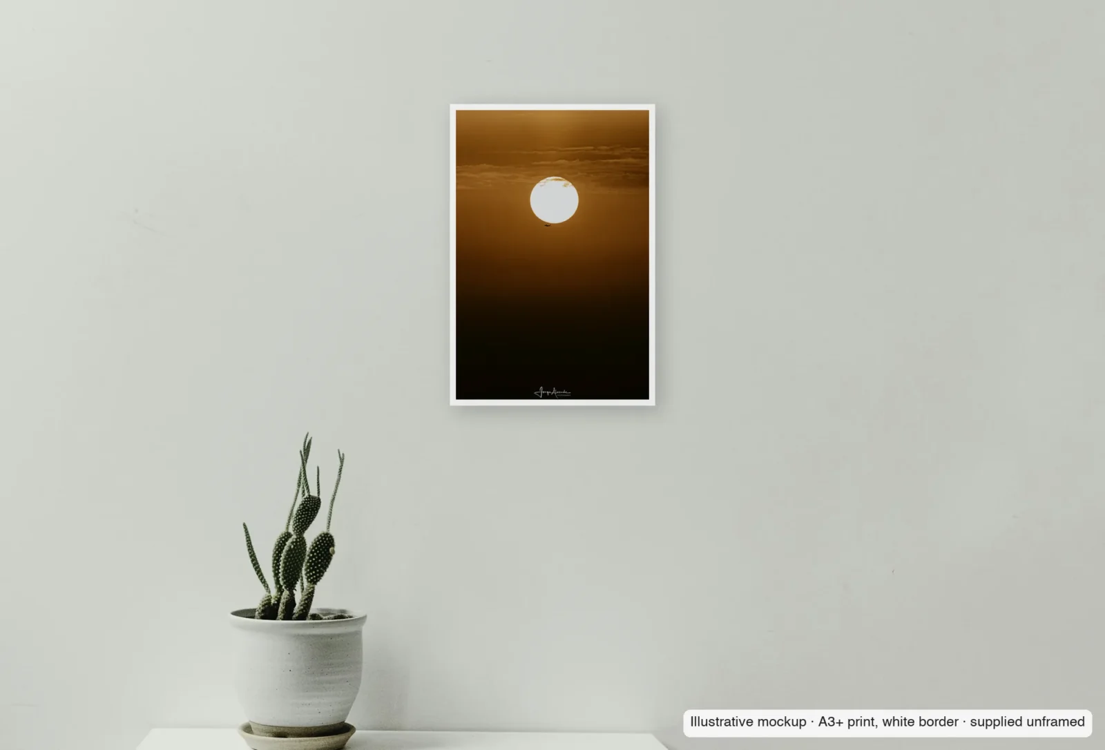 Closer view of A speck against the sun as an unframed A3+ white-border print above a sideboard.