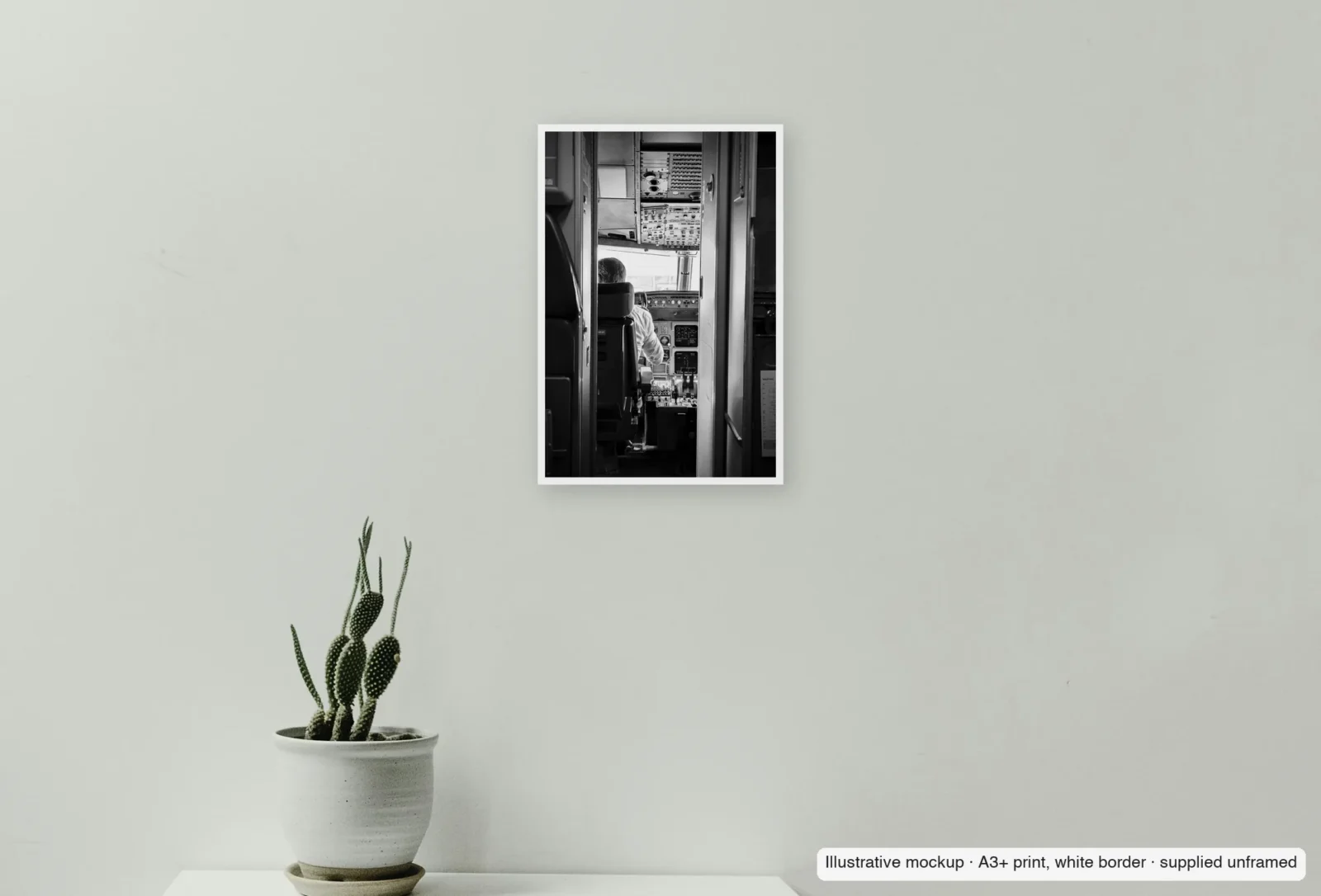 Closer view of Before pushback as an unframed A3+ white-border print above a sideboard.
