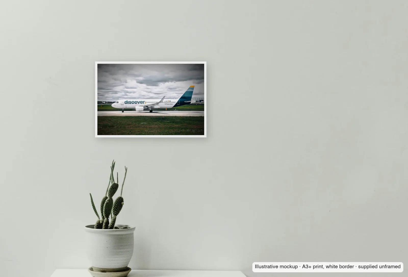 Closer view of Discover, on the taxiway as an unframed A3+ white-border print above a sideboard.