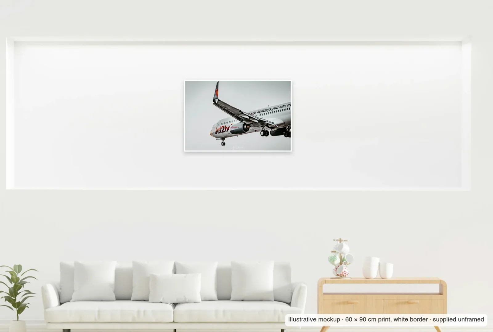 Illustrative mockup showing the scale of Flaps down, gear down as an unframed 60 × 90 cm print above a sofa.