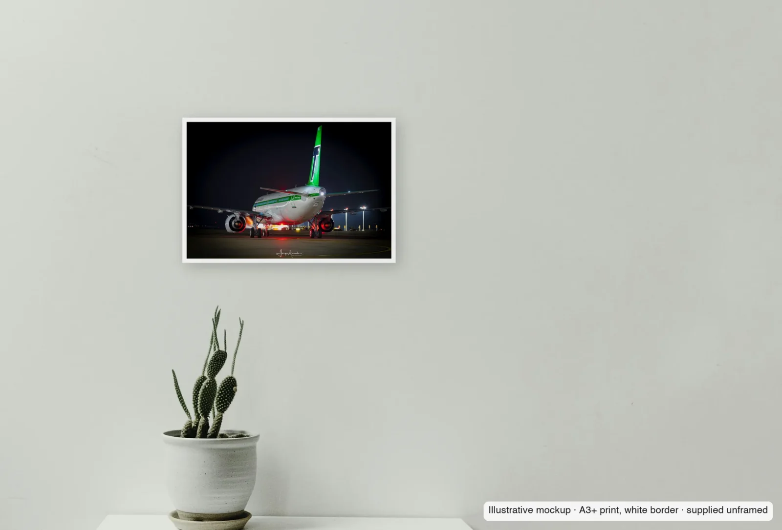 Closer view of Green tail, red beacon as an unframed A3+ white-border print above a sideboard.