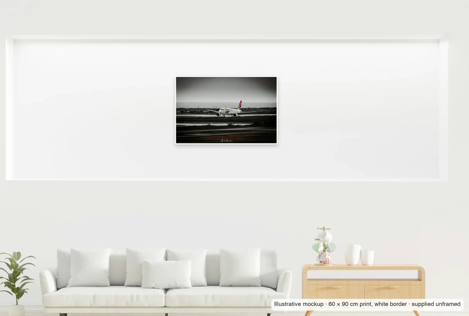 Illustrative mockup showing the scale of Over the lagoon as an unframed 60 × 90 cm print above a sofa.