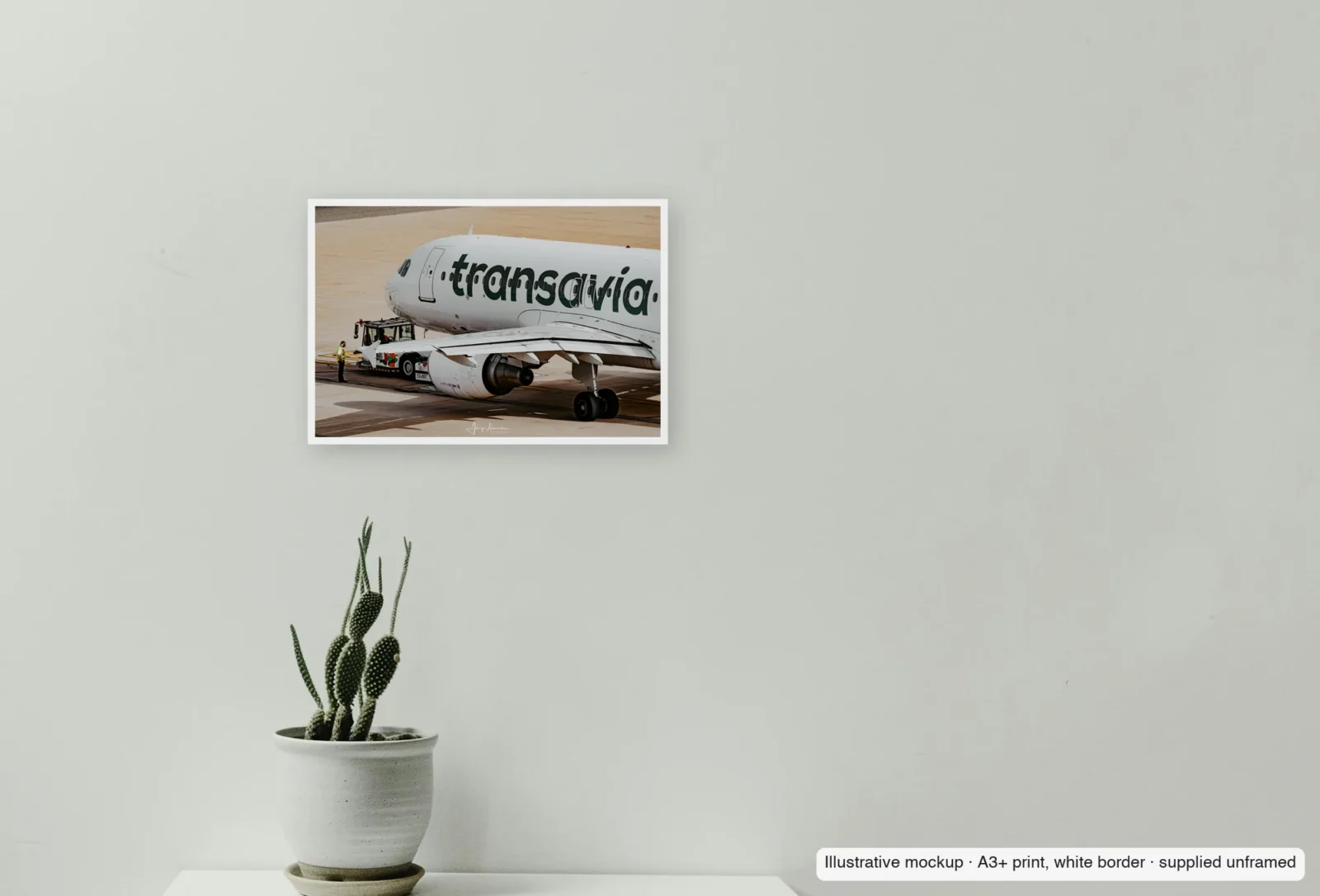 Closer view of Pushback as an unframed A3+ white-border print above a sideboard.
