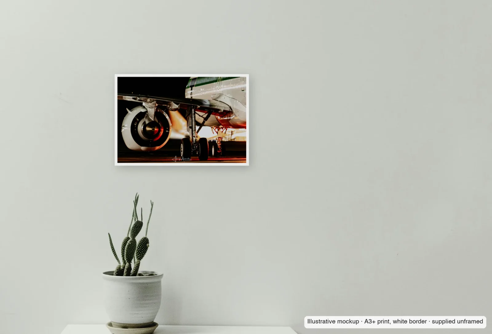 Closer view of Retro at rest as an unframed A3+ white-border print above a sideboard.