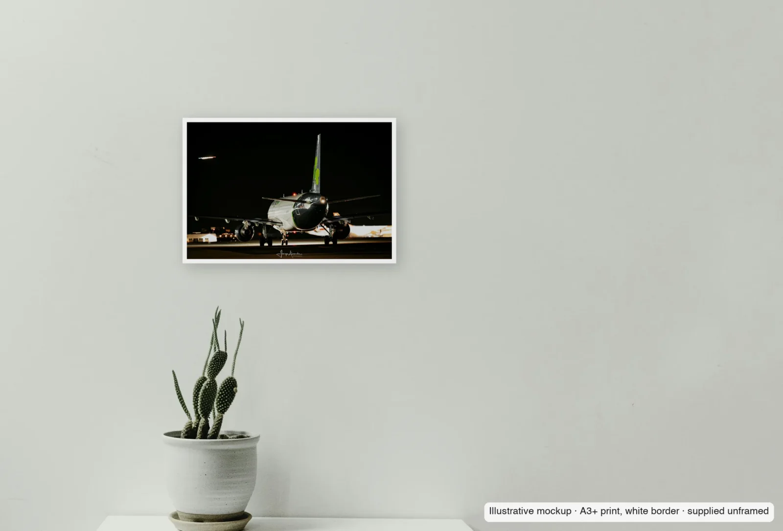Closer view of Shamrock at night as an unframed A3+ white-border print above a sideboard.