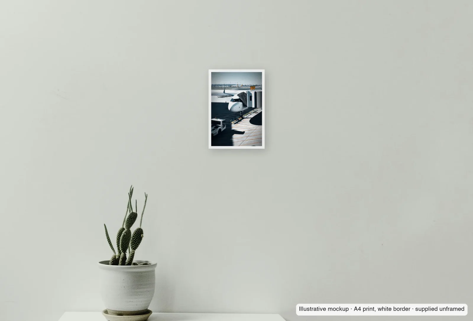 Closer view of Stand 142 as an unframed A4 white-border print above a sideboard.
