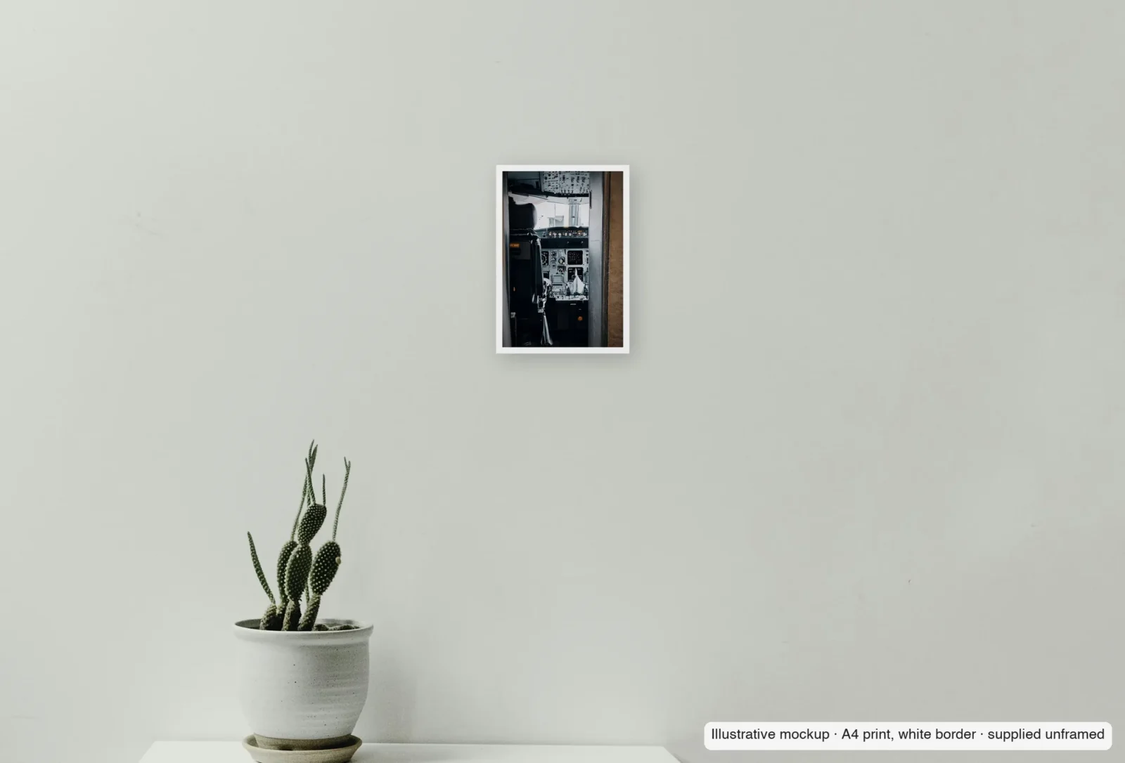 Closer view of Through the flight-deck door as an unframed A4 white-border print above a sideboard.
